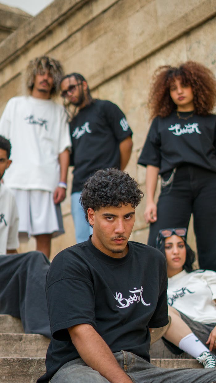 The Art of Drawing Readers In: Your attractive post title goes here Trendy young adults in urban streetwear pose on stone steps in Morocco.