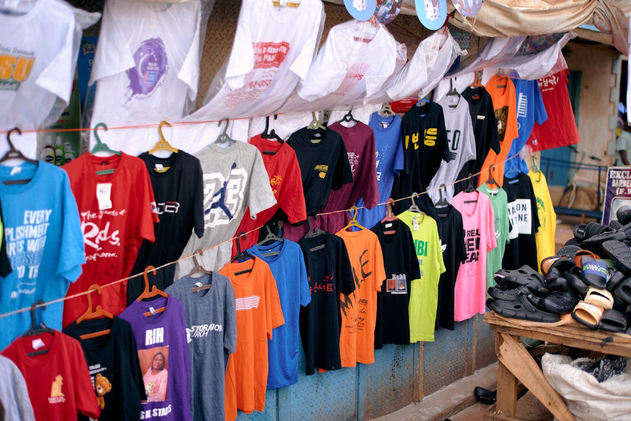 Crafting Captivating Headlines: Your awesome post title goes here Vibrant collection of T-shirts and shoes on display at an outdoor market stall in Jos, Nigeria.